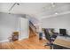 Bright office leading to staircase, hardwood floors, natural light, and modern track lighting at 9626 Whitecliff Pl, Highlands Ranch, CO 80129