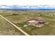 Expansive aerial view of land, highlighting lush pastures, farm buildings, and potential for rural living at 28505 County Road 5, Elizabeth, CO 80107