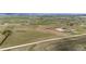 Aerial view of property showing rolling green pastures, complemented by a clear blue sky dotted with fluffy clouds at 28505 County Road 5, Elizabeth, CO 80107