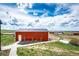 Exterior featuring a functional barn set on expansive acreage with vibrant green grass at 28505 County Road 5, Elizabeth, CO 80107