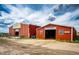 Exterior of two red barns; one with open doors and the other with a partially open door at 28505 County Road 5, Elizabeth, CO 80107