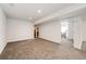 Finished basement with neutral carpeting, white walls, and a view into another room at 28505 County Road 5, Elizabeth, CO 80107