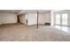 Spacious finished basement featuring neutral carpet, white walls, and a partial view of the tile flooring at 28505 County Road 5, Elizabeth, CO 80107