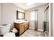Bathroom with double sinks, framed mirror, a skylight, and a glass-enclosed shower at 28505 County Road 5, Elizabeth, CO 80107