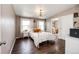 Cozy bedroom with a chandelier, natural light, and an adjacent bathroom entrance at 28505 County Road 5, Elizabeth, CO 80107