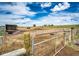 Exterior shot of an equestrian fenced area in a rural setting with a metal gate at 28505 County Road 5, Elizabeth, CO 80107