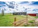 Exterior view of the home with a fenced yard and barn at 28505 County Road 5, Elizabeth, CO 80107