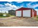 Garage exterior boasts a vibrant red facade and multiple garage doors, offering ample storage and parking space at 28505 County Road 5, Elizabeth, CO 80107