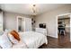 Comfortable bedroom featuring a decorative chandelier, connecting bathroom, and access to kitchen at 28505 County Road 5, Elizabeth, CO 80107