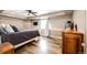 Finished main bedroom featuring wood floors, a tray ceiling, and a large bed at 28505 County Road 5, Elizabeth, CO 80107