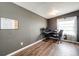 Bright office space featuring dark wood floors, gray walls, and a computer desk near a large window at 28505 County Road 5, Elizabeth, CO 80107