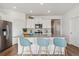 Open concept kitchen with white cabinets, gray countertops, and an island at 2237 Crosswind St, Fort Lupton, CO 80621