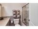 Cozy bathroom showcasing a shower with glass door and mosaic tile accents at 14892 E Arkansas Dr, Aurora, CO 80012