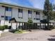 Apartment building exterior with covered entry, and manicured landscaping at 8826 E Florida Ave # 204, Denver, CO 80247