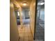 Hallway with tiled floors, neutral paint, and recessed lighting, providing a clean transition between rooms at 8826 E Florida Ave # 204, Denver, CO 80247
