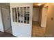 Galley kitchen area with white cabinetry, tile floor, and appliances view at 8826 E Florida Ave # 204, Denver, CO 80247