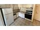 Functional kitchen with white cabinets and appliances, and tiled floor at 8826 E Florida Ave # 204, Denver, CO 80247