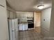Compact kitchen featuring modern appliances and ample cabinet space at 8826 E Florida Ave # 204, Denver, CO 80247