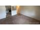 Living room leading to the kitchen featuring neutral walls and carpet at 8826 E Florida Ave # 204, Denver, CO 80247