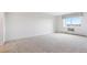 Bright and spacious bedroom with neutral walls, carpeting and large window at 14050 E Linvale Pl # 601, Aurora, CO 80014