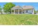 Expansive backyard featuring a covered patio with ample seating and a well-maintained lawn at 29852 E 163Rd Pl, Brighton, CO 80603