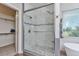 Bathroom featuring a glass-enclosed shower with mosaic tile accents and a walk-in closet at 29852 E 163Rd Pl, Brighton, CO 80603