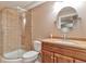 Bathroom featuring glass enclosed shower, toilet, vanity and decorative mirror at 29852 E 163Rd Pl, Brighton, CO 80603