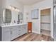 Well-lit bathroom with double sinks, modern fixtures, and a walk-in closet offering ample storage at 29852 E 163Rd Pl, Brighton, CO 80603