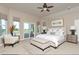 Serene bedroom with a large bed, sitting area, and sliding glass door to a private balcony at 29852 E 163Rd Pl, Brighton, CO 80603