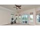 Bedroom with a ceiling fan, multiple windows with backyard views, and a sliding glass door at 29852 E 163Rd Pl, Brighton, CO 80603