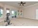 Bright bedroom with a ceiling fan, multiple windows with backyard views, and a sliding glass door at 29852 E 163Rd Pl, Brighton, CO 80603