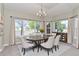 Elegant dining room featuring large windows and a modern chandelier at 29852 E 163Rd Pl, Brighton, CO 80603