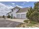 Two-story home showcasing a three-car garage, neutral siding, and manicured landscaping at 29852 E 163Rd Pl, Brighton, CO 80603