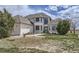 Well-maintained home boasts arched windows and inviting entrance with mature trees at 29852 E 163Rd Pl, Brighton, CO 80603