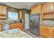 Bright kitchen boasts stainless appliances, wooden cabinetry, and granite countertops at 29852 E 163Rd Pl, Brighton, CO 80603