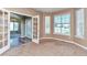 Bright living room featuring large windows, neutral tones, and glass french doors at 29852 E 163Rd Pl, Brighton, CO 80603