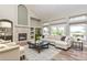 Bright living room with a cozy fireplace, built-in shelves, and a sliding glass door leading to the backyard at 29852 E 163Rd Pl, Brighton, CO 80603