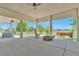 Covered patio with a fire pit, rocking chair, and views of the backyard at 29852 E 163Rd Pl, Brighton, CO 80603