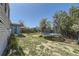 Large backyard featuring a trampoline, fire pit area, and partially covered patio at 19502 E Buchanan Pl, Aurora, CO 80011