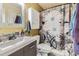 The bathroom features a unique shower curtain, sink, modern cabinet, and a decorative mirror at 19502 E Buchanan Pl, Aurora, CO 80011