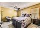 Bedroom with ceiling fan, neutral-toned walls, plush queen bed, and wood-look flooring at 19502 E Buchanan Pl, Aurora, CO 80011