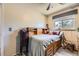 Bedroom featuring a wood-frame bed with storage, ceiling fan, window, and wood flooring at 19502 E Buchanan Pl, Aurora, CO 80011