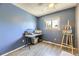Blue bedroom featuring a window, wood flooring, ceiling fan, and a desk with a painting easel at 19502 E Buchanan Pl, Aurora, CO 80011