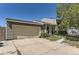 Split level home featuring beige siding and a two car garage in a suburban neighborhood at 19502 E Buchanan Pl, Aurora, CO 80011