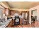 Functional kitchen with sleek countertops, stainless steel refrigerator, and dark wood cabinetry at 19502 E Buchanan Pl, Aurora, CO 80011