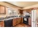 Well-lit kitchen featuring wooden cabinets, stainless steel appliances, and hardwood floors at 19502 E Buchanan Pl, Aurora, CO 80011