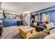Cozy living room with fireplace, plush sofa, accent lighting, and stairs to upper level at 19502 E Buchanan Pl, Aurora, CO 80011