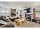 Spacious living room with large tv, decorative fireplace, plush sofa, and accent lighting at 19502 E Buchanan Pl, Aurora, CO 80011