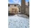 Back exterior of the property showing a patio and stone fireplace at 442 S Kalispell Way # C, Aurora, CO 80017