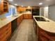 Kitchen with granite countertops, wooden cabinets, and tile flooring at 442 S Kalispell Way # C, Aurora, CO 80017